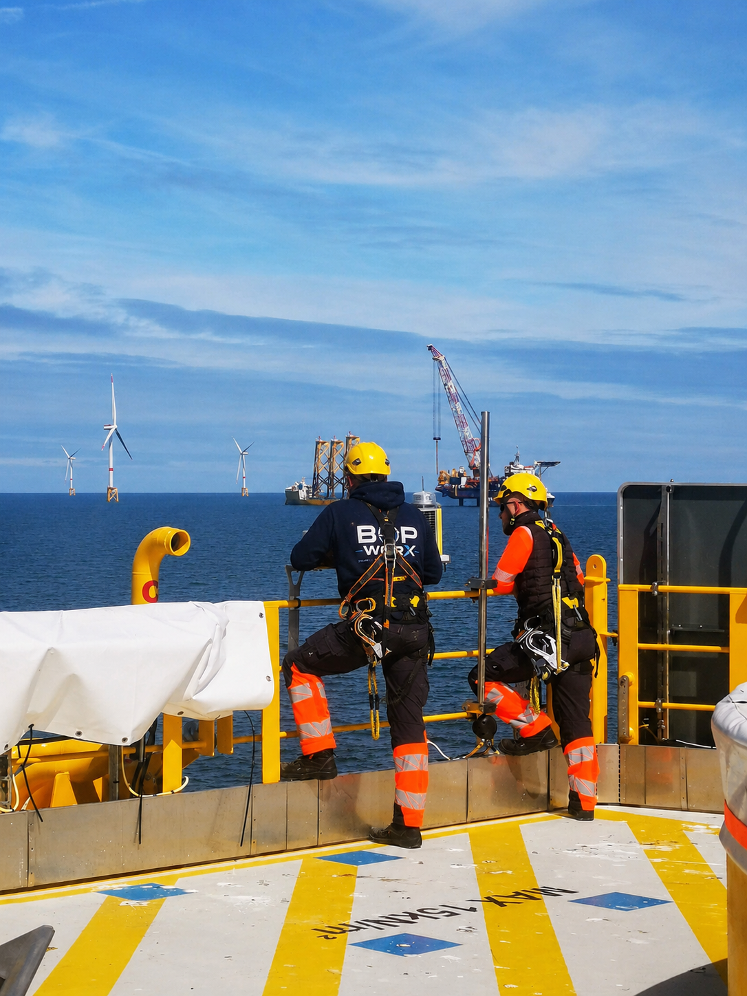 BOP WorX technicians on offshore platform overlooking wind farm