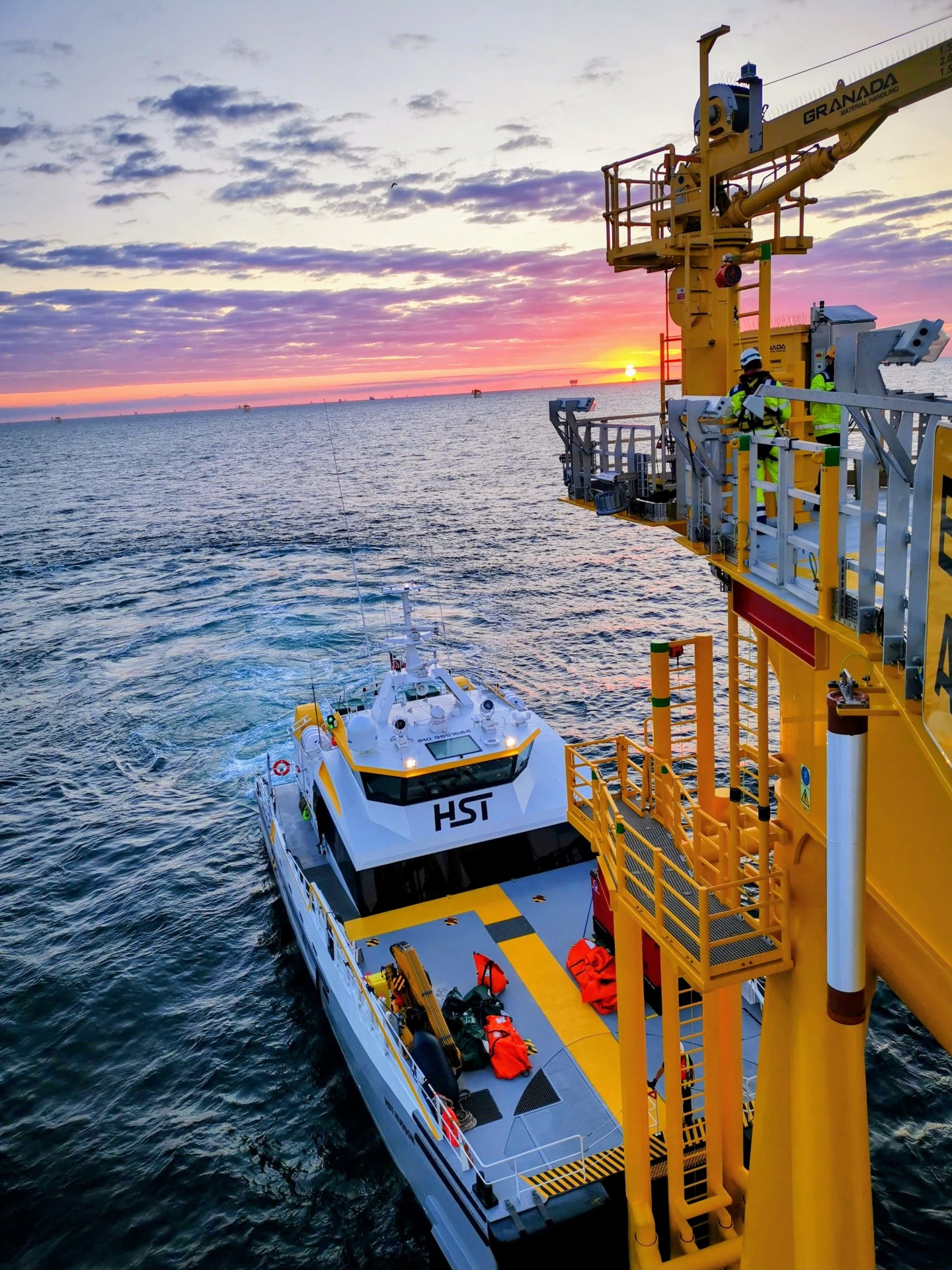 CTV alongside turbine at sunset